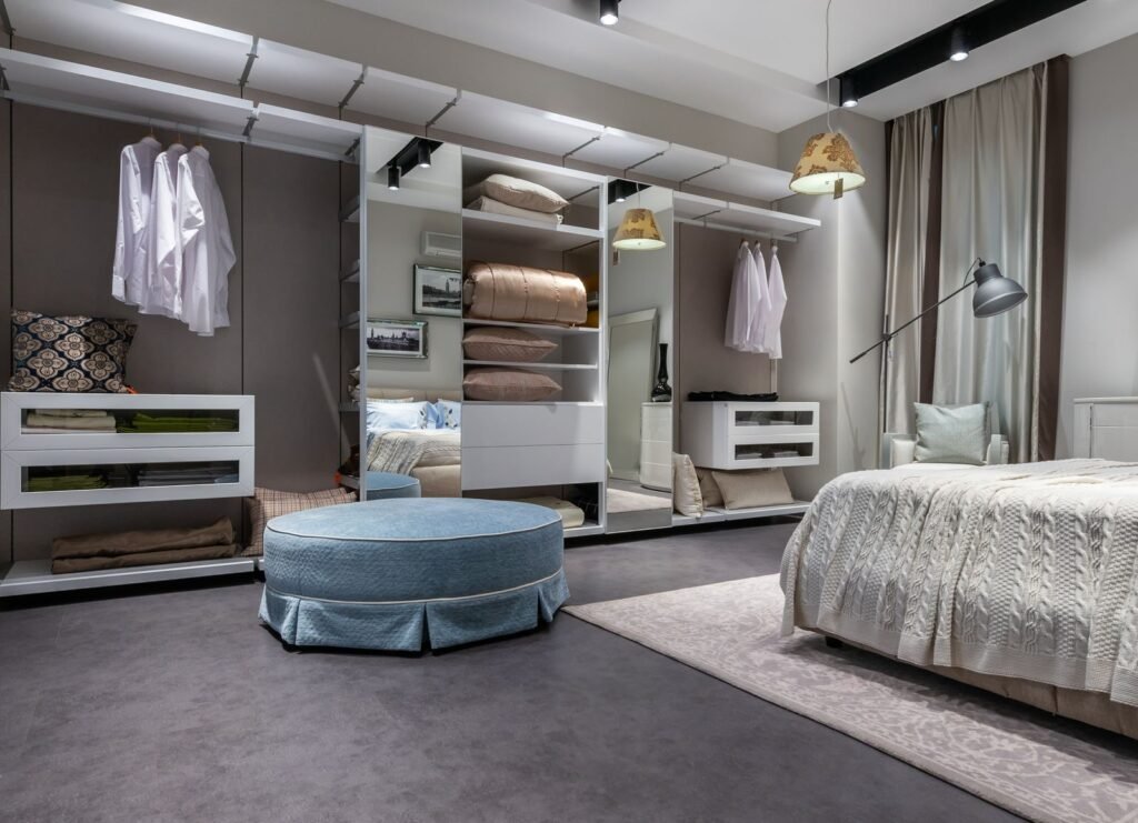 Bedroom with open built-in storage, hanging space and a mirror (illustrative stock image)