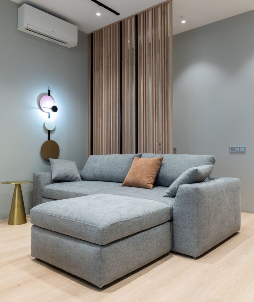 Grey corner sofa with side table (illustrative stock image)