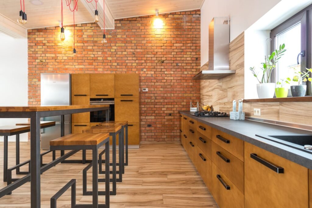 Contemporary kitchen with a brick wall and wooden cabinets (illustrative stock image)