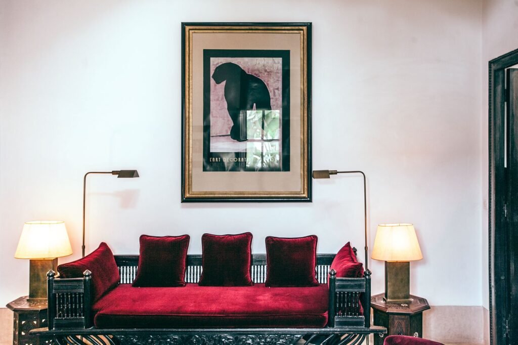 Red velvet sofa with table lamps (illustrative stock image)