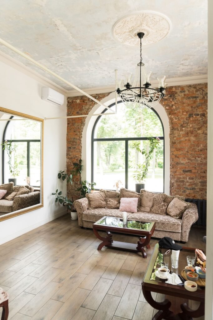 Living room with sofa and arched window (illustrative stock image)