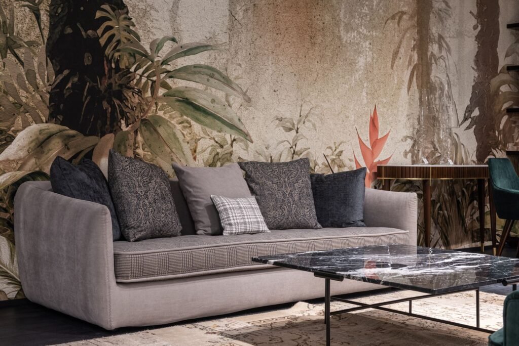 Sofa with cushions and botanical wall (illustrative stock image)