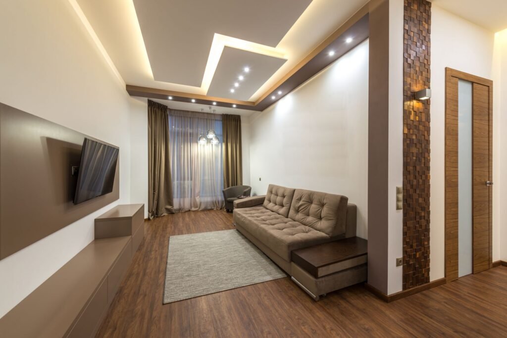 Living room with a tray ceiling, cove light and spotlights (illustrative stock image)