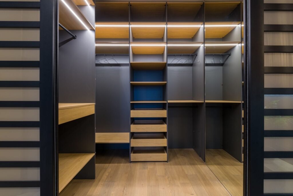 Walk-in closet with wooden shelves (illustrative stock image)