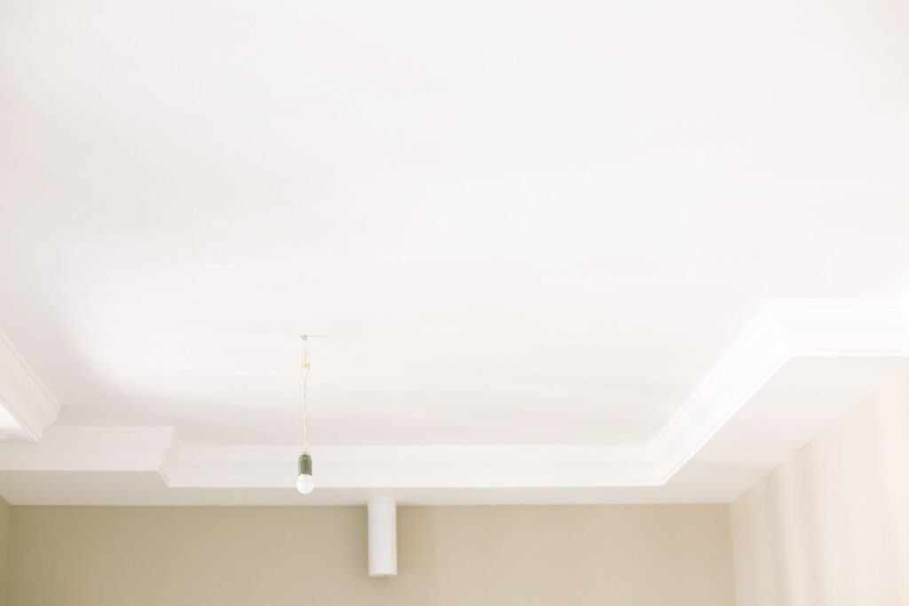 White stepped border ceiling with a hanging pendant light (illustrative stock image)
