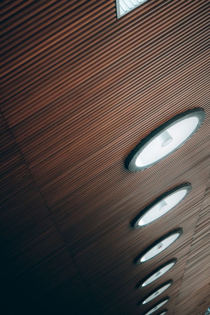 Wooden slat ceiling with round recessed light fittings (illustrative stock image)