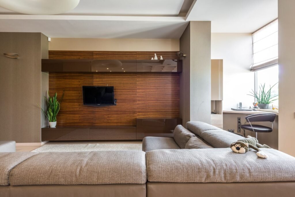 Living room with a wooden TV wall panel and low cabinet (illustrative stock image)