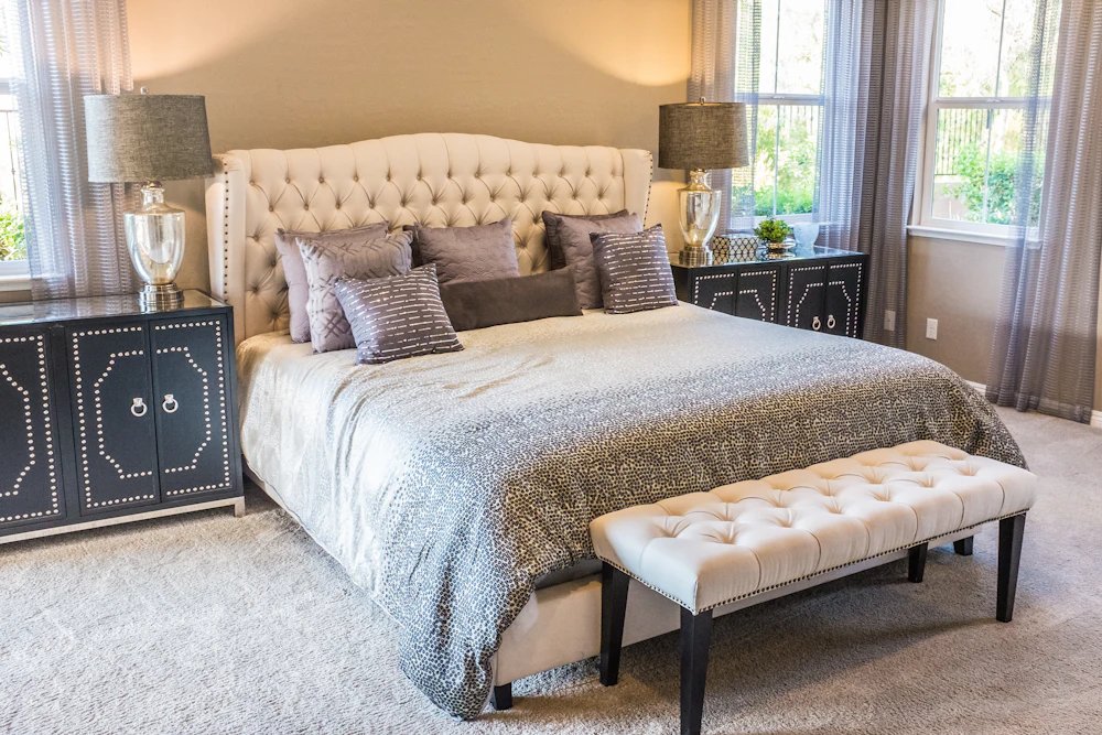 Bedroom with tufted headboard and upholstered bench (illustrative image)