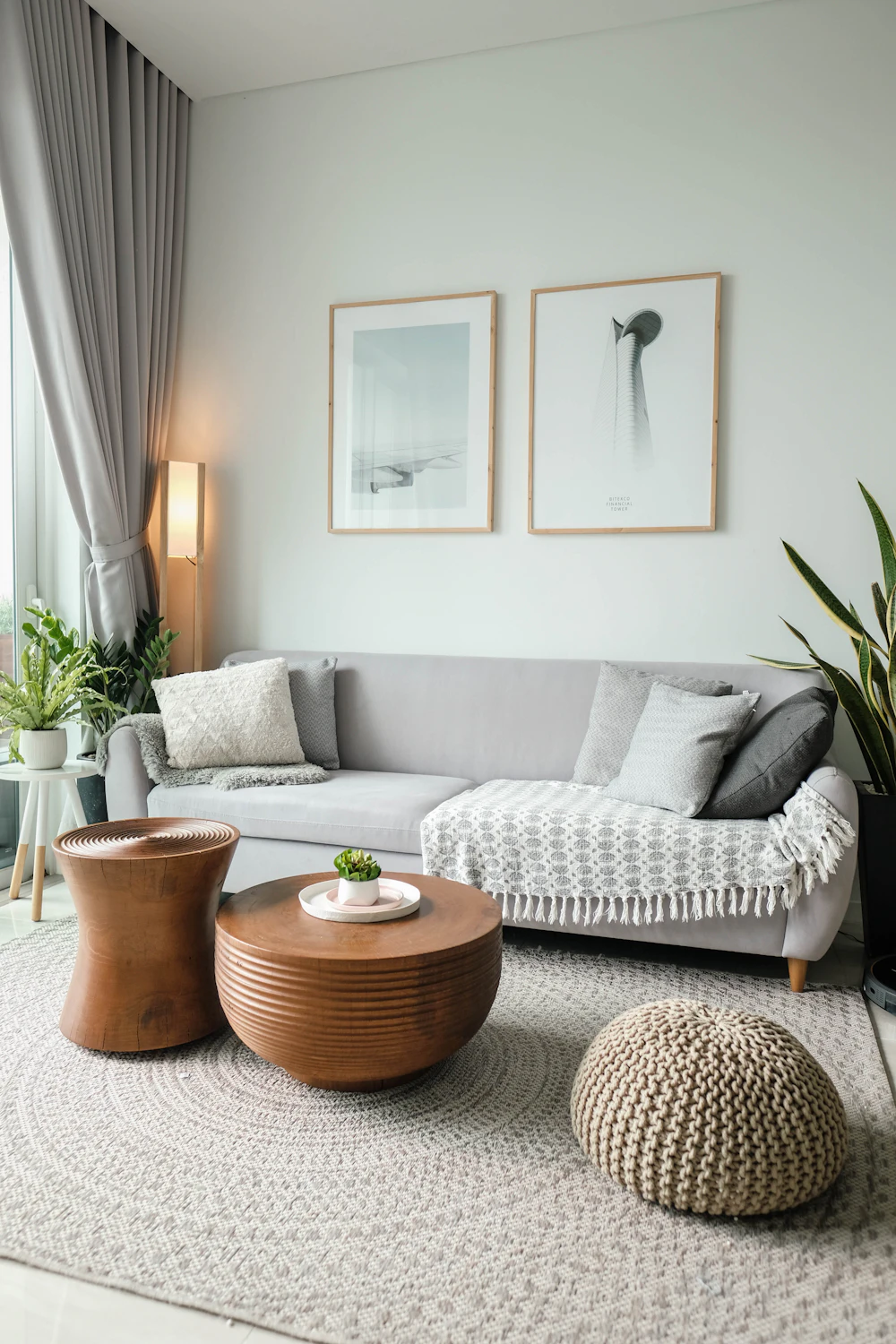 Living room with grey sofa, side tables and framed art (illustrative image)