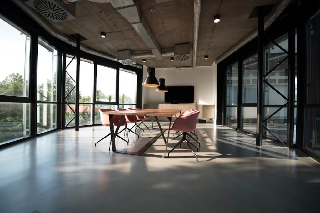Open office interior with long table and large windows (illustrative image)